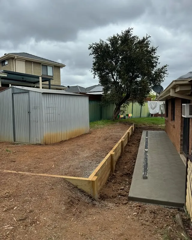 New timber retaining wall and concrete strip drain in a Campbelltown backyard