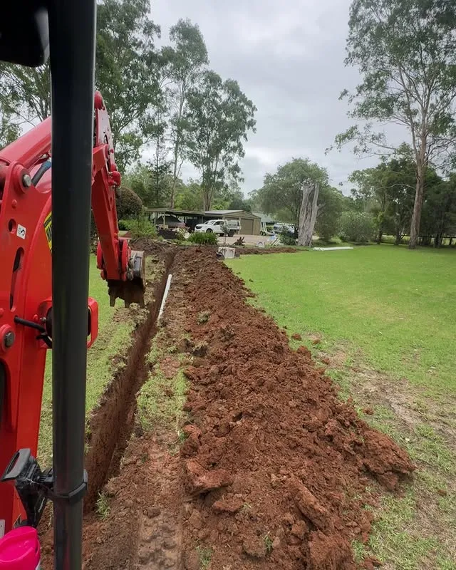 Nexus Group excavator digging a drainage trench across a Wilberforce property